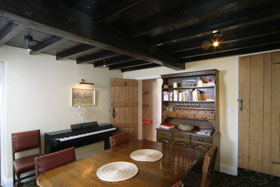 Dining room of holiday cottage with piano